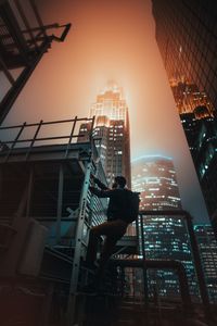 a man climbing a ladder on a rooftop